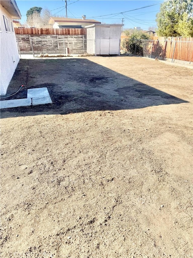 view of yard featuring a fenced backyard and an outdoor structure