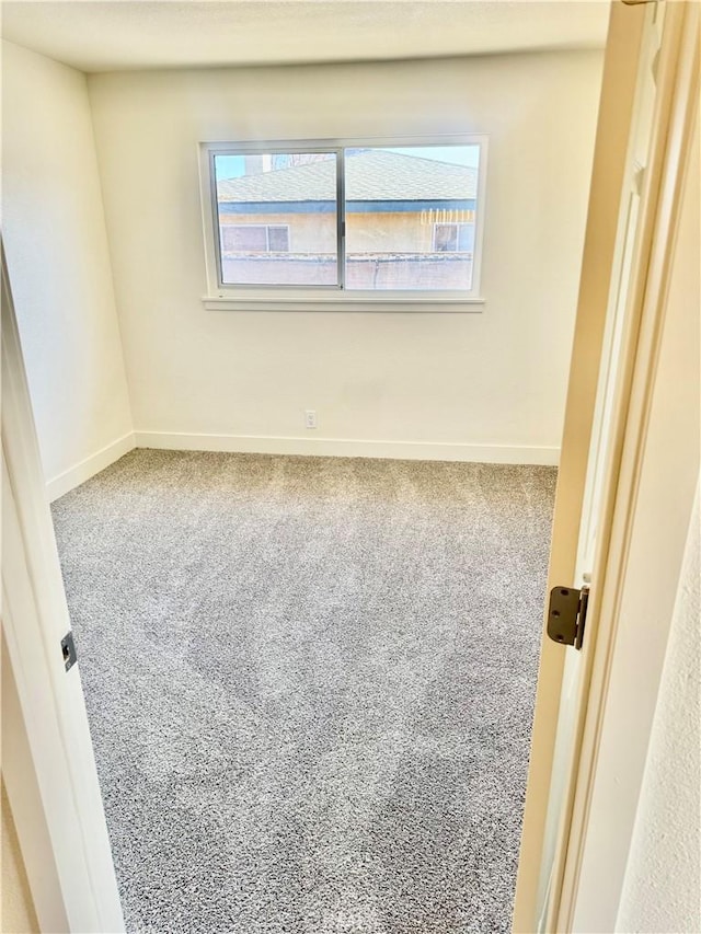 carpeted empty room featuring plenty of natural light and baseboards