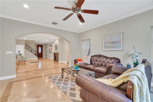 living room featuring ceiling fan and crown molding