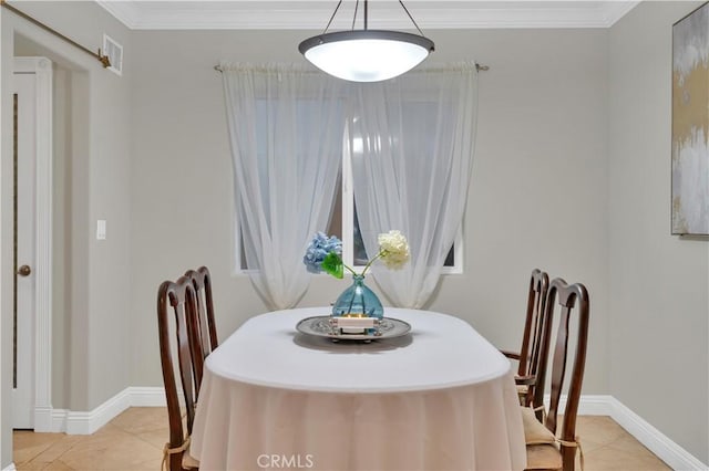 dining area featuring ornamental molding and light tile patterned floors