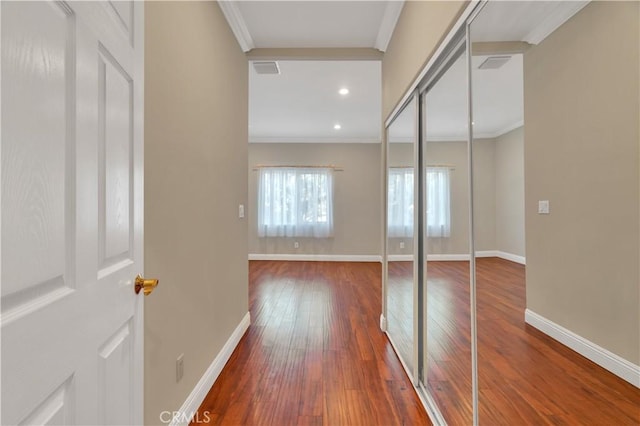 hall featuring dark hardwood / wood-style floors and ornamental molding