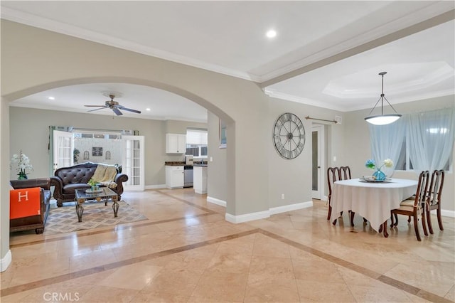 dining area featuring ceiling fan, crown molding, and a tray ceiling