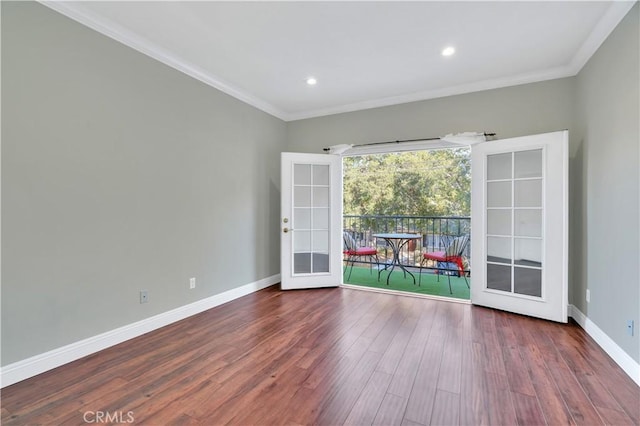 spare room featuring wood-type flooring, ornamental molding, and french doors