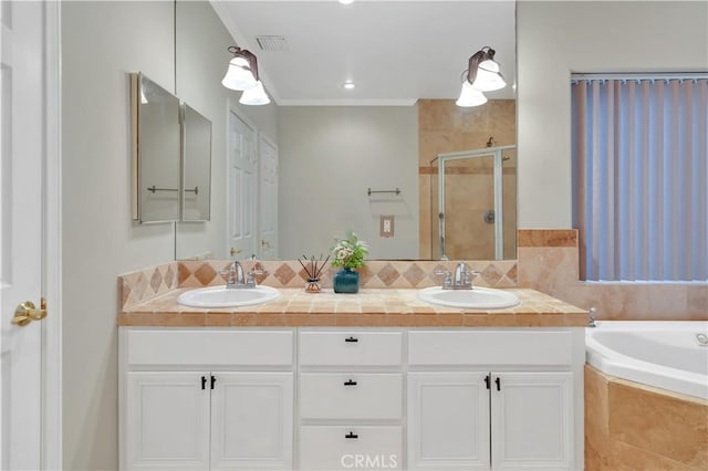 bathroom with vanity, crown molding, and separate shower and tub