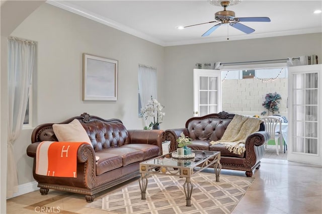 living room with ceiling fan, ornamental molding, and light tile patterned flooring