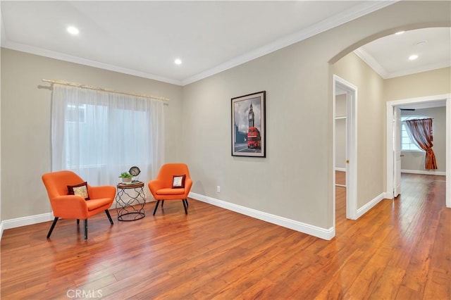 sitting room featuring light hardwood / wood-style flooring and crown molding