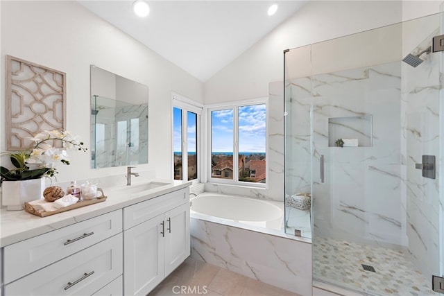 bathroom featuring vaulted ceiling, separate shower and tub, vanity, and tile patterned floors