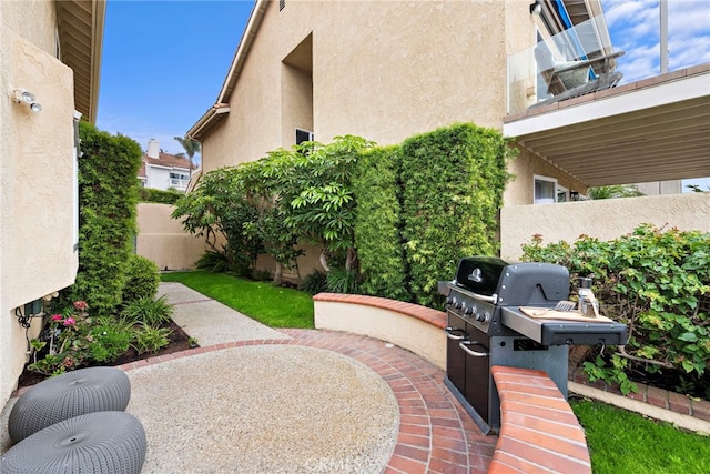 view of patio / terrace featuring a balcony and a grill