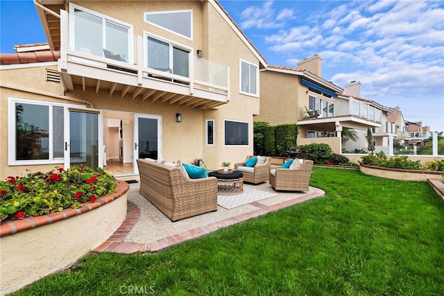 rear view of house featuring a balcony, a yard, an outdoor hangout area, and a patio area