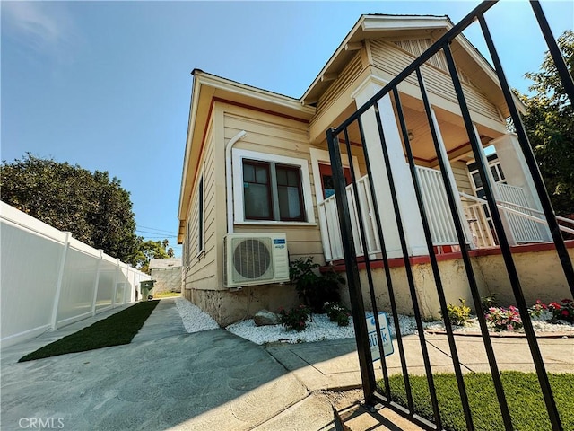 view of side of home with ac unit