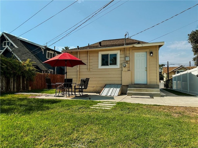 back of house featuring a yard and a patio area