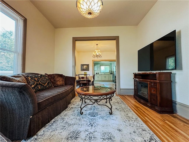 living room with a notable chandelier and wood-type flooring