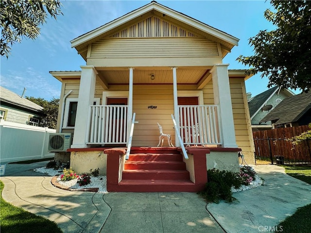 view of front of house featuring covered porch and ac unit