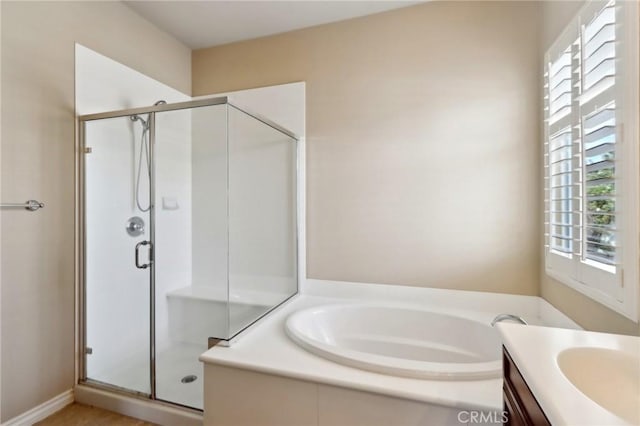 bathroom featuring vanity and separate shower and tub