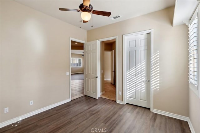 unfurnished bedroom with ceiling fan and hardwood / wood-style flooring