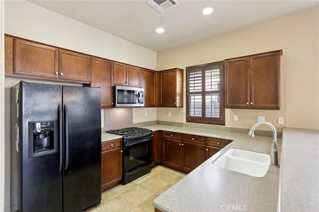 kitchen featuring sink and black appliances