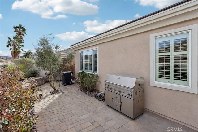 view of patio / terrace featuring cooling unit and a grill