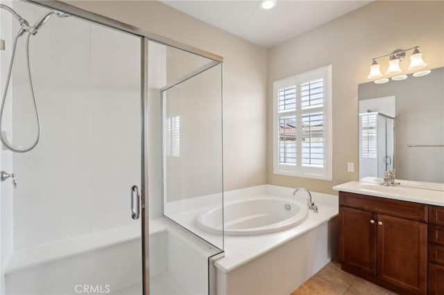 bathroom with independent shower and bath, tile patterned flooring, and vanity