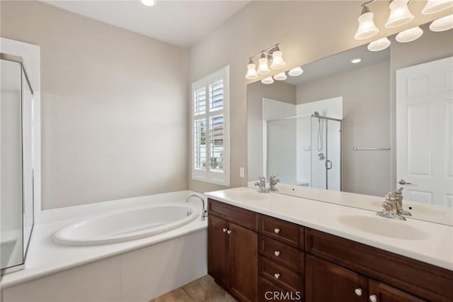 bathroom featuring independent shower and bath, tile patterned floors, and vanity