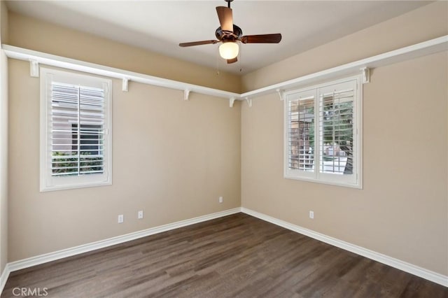 unfurnished room featuring ceiling fan and dark hardwood / wood-style floors