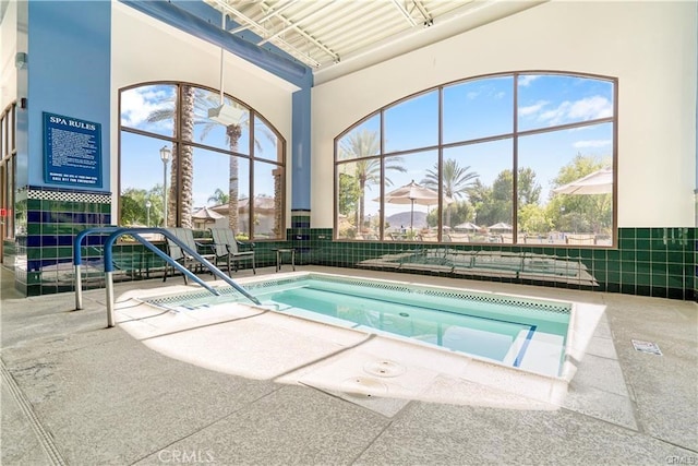 view of swimming pool with a community hot tub