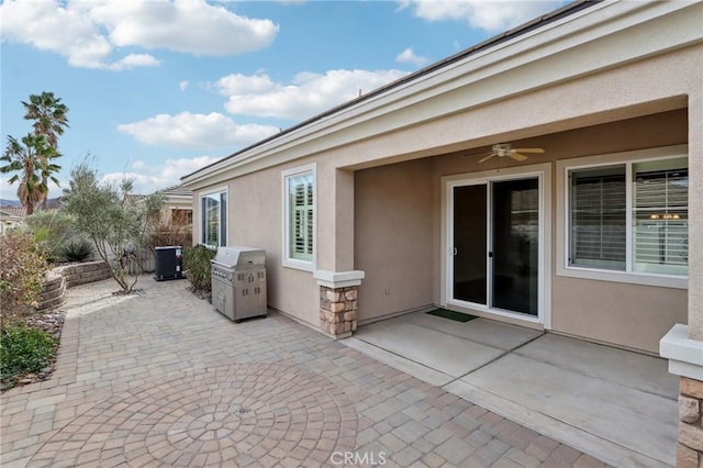 view of patio with central air condition unit, grilling area, and ceiling fan