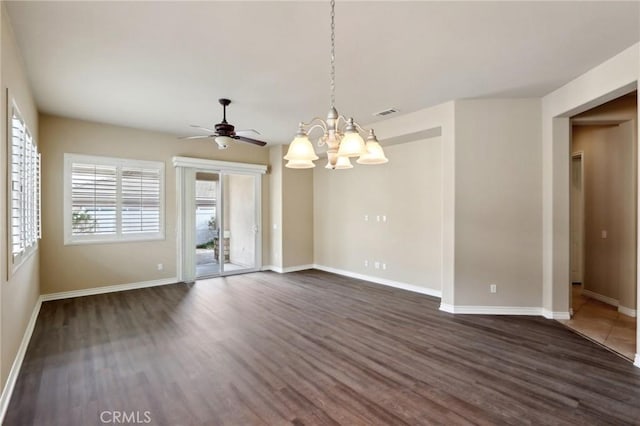 spare room featuring ceiling fan with notable chandelier and dark hardwood / wood-style flooring