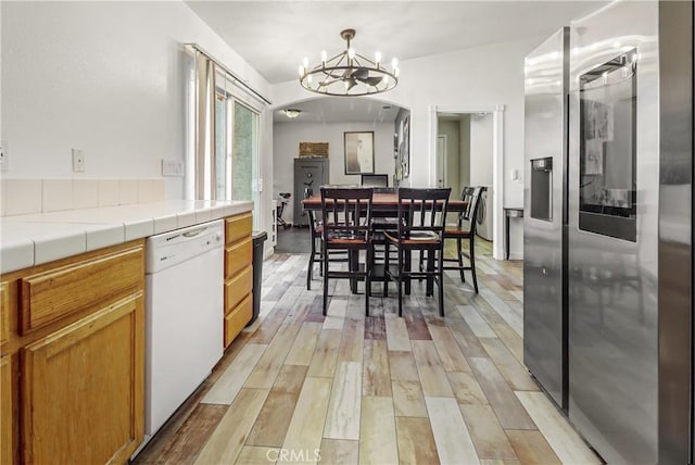 dining space featuring a chandelier and light wood-type flooring