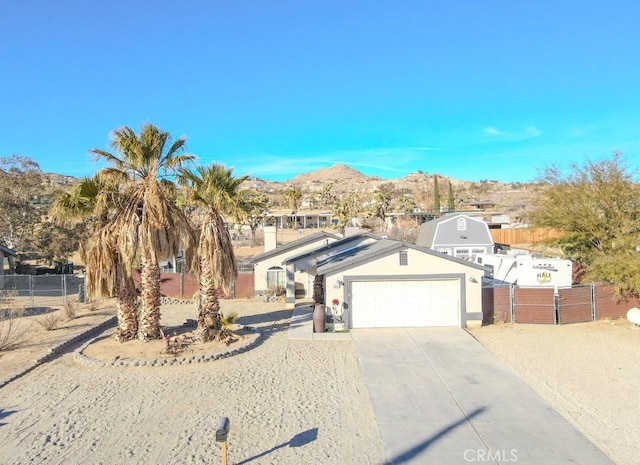 view of front facade featuring a garage and a mountain view