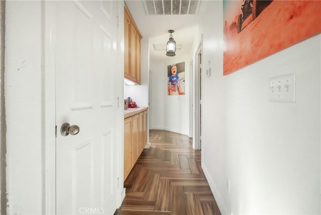 corridor featuring dark parquet flooring