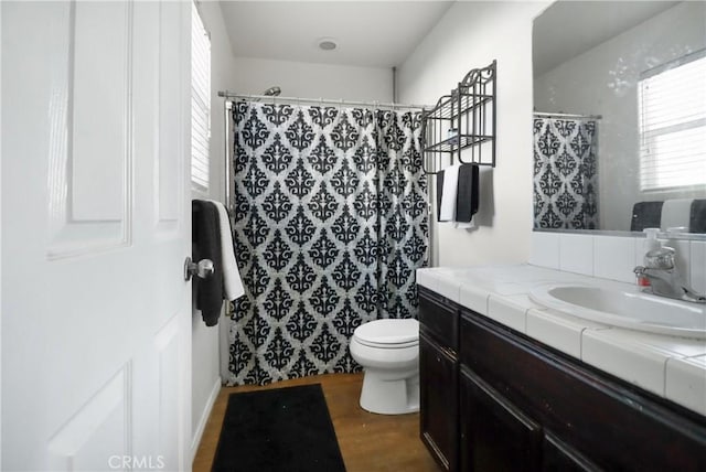 bathroom featuring hardwood / wood-style flooring, vanity, a shower with curtain, and toilet