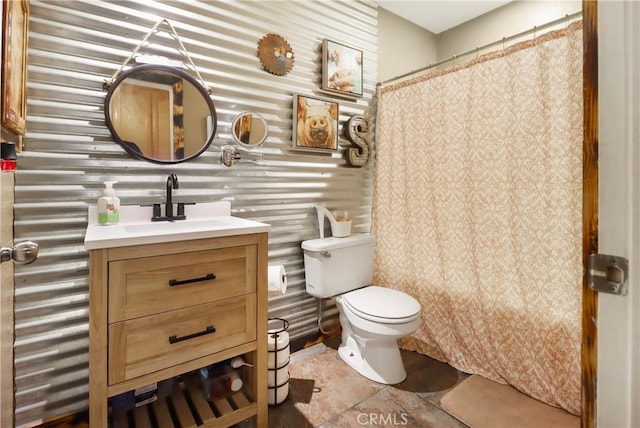 bathroom with vanity, walk in shower, and toilet