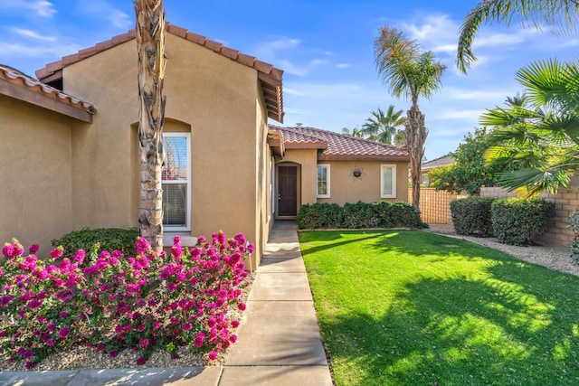 property entrance featuring a lawn