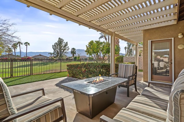 view of patio / terrace with a mountain view, an outdoor living space with a fire pit, and a pergola