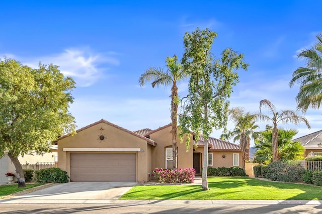 mediterranean / spanish-style home featuring a garage and a front lawn