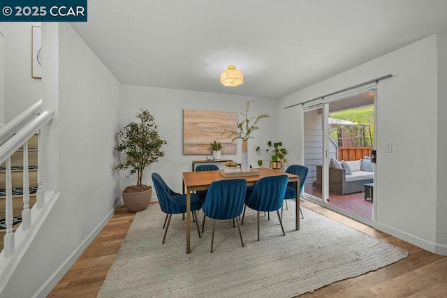 dining space with hardwood / wood-style floors