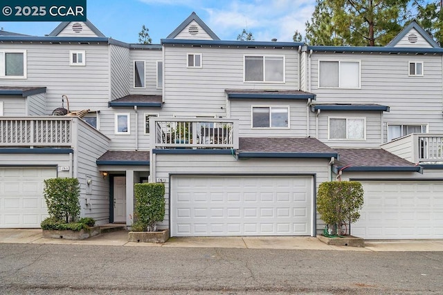 townhome / multi-family property featuring a garage and a balcony