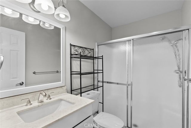 bathroom featuring toilet, a shower stall, and vanity