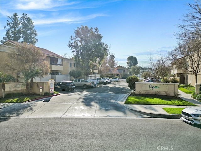 view of road featuring sidewalks, a residential view, and curbs