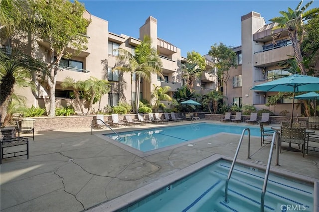 view of pool featuring a residential view and a patio area