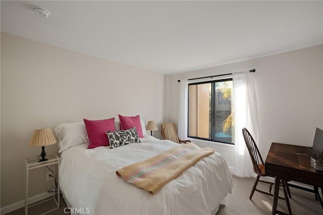 carpeted bedroom with baseboards