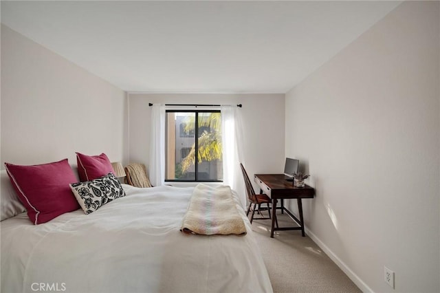 bedroom featuring carpet and baseboards