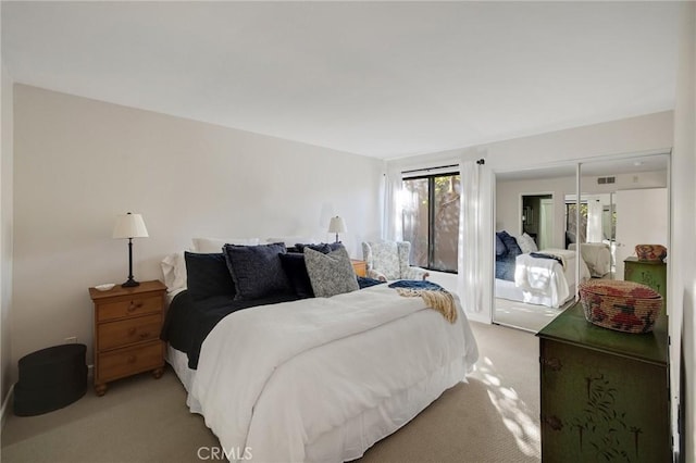 bedroom featuring light colored carpet and visible vents