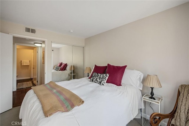 bedroom with a closet and visible vents