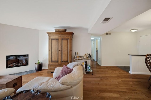 8300 Manitoba St Unit 222, Playa Del Rey, CA 90293 - living room featuring wood finished floors, baseboards, and a glass covered fireplace