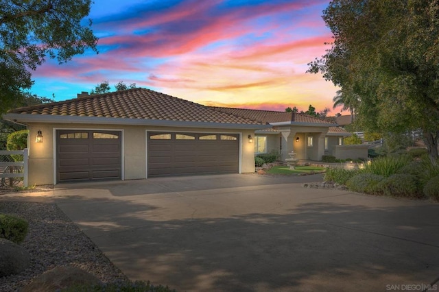 mediterranean / spanish-style house featuring a garage