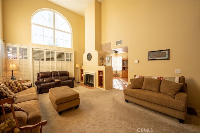 carpeted living room with high vaulted ceiling