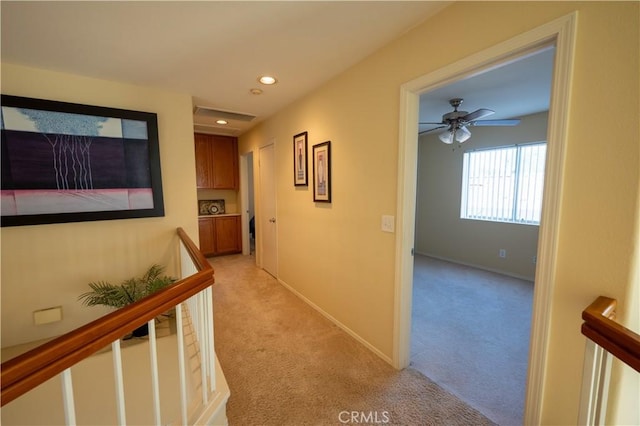 corridor featuring light colored carpet