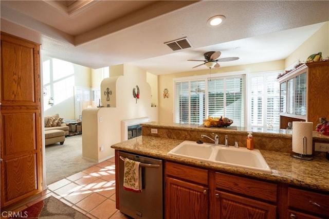 kitchen with sink, light colored carpet, dishwasher, and ceiling fan