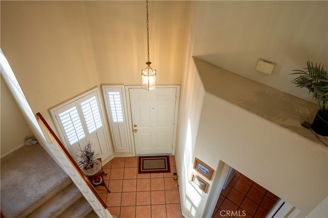 tiled entrance foyer with a high ceiling